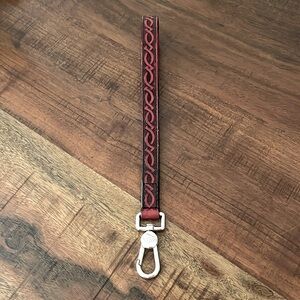 Consuela leather wristlet strap in red.